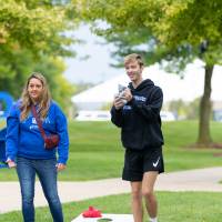 Individuals playing cornhole